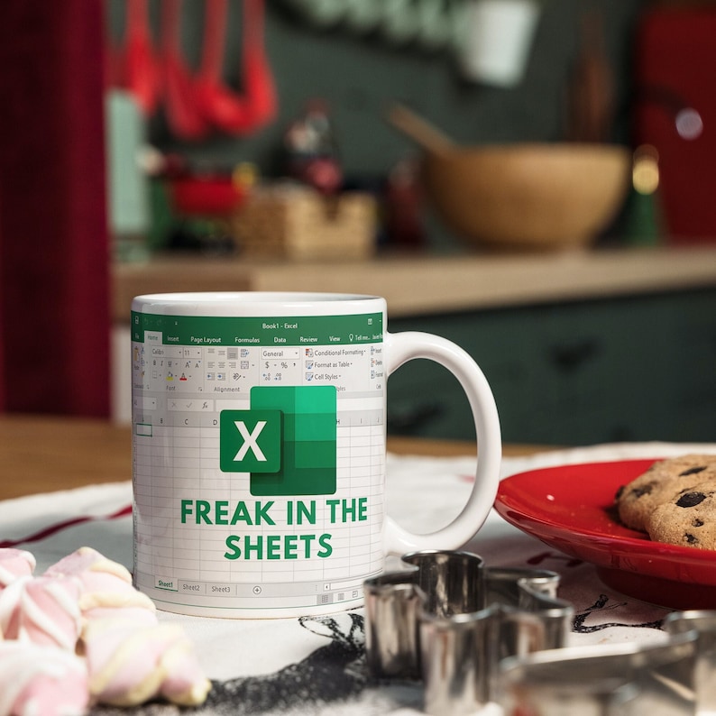 White ceramic 11oz Freak In The Sheets Excel mug with a graphic showing an Excel spreadsheet and the words Freak in the sheets. Perfect funny gift for a coworker, boss and friend.