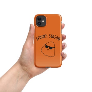 May include: Orange iPhone case with a black ghost wearing sunglasses and the text "Spooky Season".