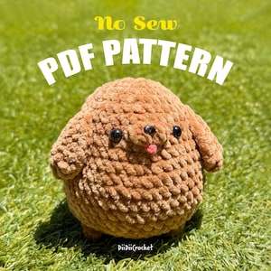 May include: A brown crocheted plush toy dog with black eyes and a pink tongue. The toy is sitting on a green grassy surface. The text "No Sew PDF Pattern" is written in yellow letters above the toy.