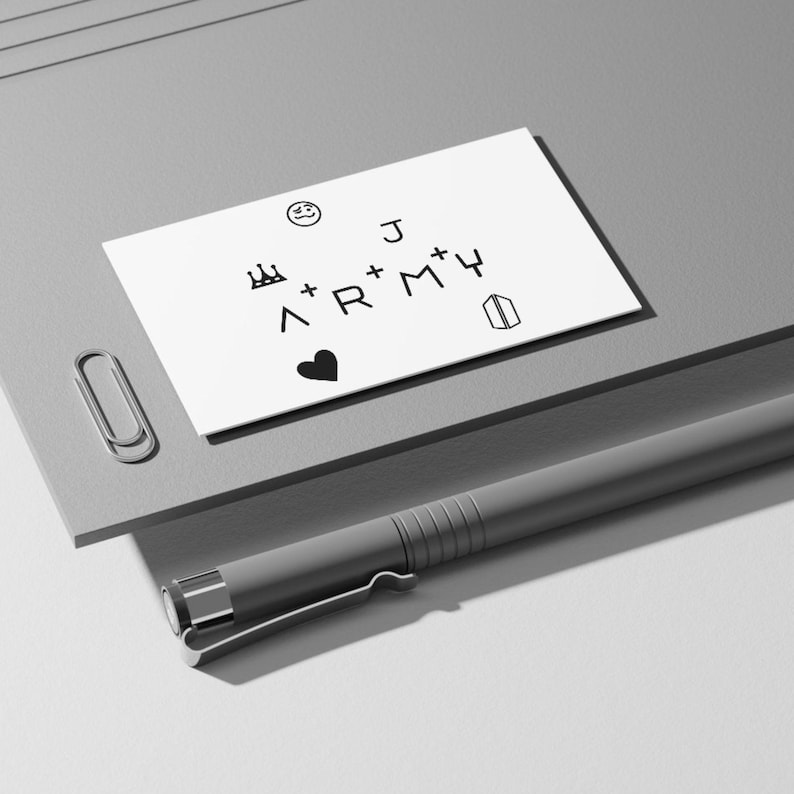 May include: A white card with black text and symbols. The text reads "J + + ARMY". There are also symbols including a crown, a heart, a smiley face, and a building.