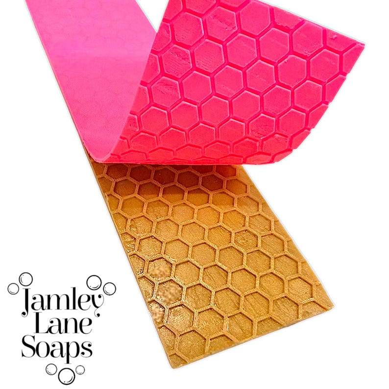 May include: A close-up of a pink and gold soap mould with a honeycomb pattern. The pink section is lifted to reveal the gold section underneath. The words "Jamley Lane Soaps" are in the lower left corner.