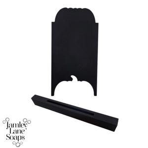 May include: Black chalkboard sign with a pumpkin cutout at the bottom. The sign is attached to a black stand.