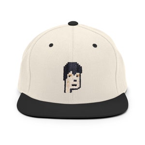 May include: A beige and black baseball cap with a pixelated embroidered image of a person's face.