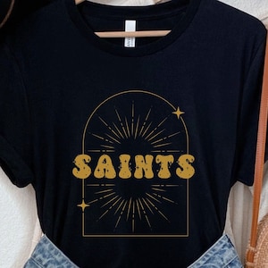Celestial Saints Tee | Retro Geaux NOLA Black and Gold NFL T-shirt | New Orleans Louisiana Team Sports Fan LA Football Shirt