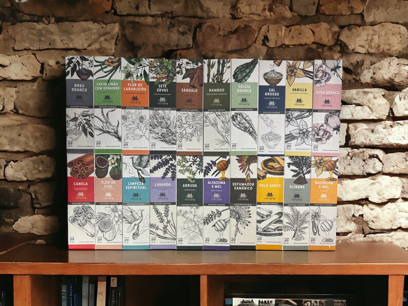 May include: A collection of 24 boxes with various botanical illustrations and Portuguese text. The boxes are arranged in two rows on a wooden shelf. The boxes are white with black text and illustrations.