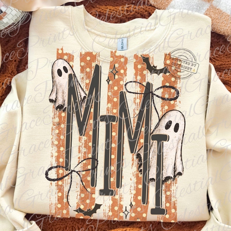 May include: A cream-colored crewneck sweatshirt featuring the text MIMI in large black letters. The design includes two white ghosts, orange vertical stripes with white polka dots, black bows, and small black bats. The Gildan brand tag is visible.