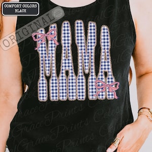 May include: Black vest top featuring the word "MAMA" in a blue and white gingham pattern, edged with a leopard print design. Pink bows are placed above and below the word. The top is labelled "Comfort Colors Black."