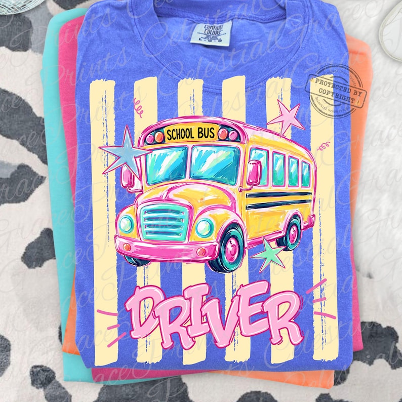 May include: A blue t-shirt featuring a graphic of a yellow school bus with the text SCHOOL BUS above it and the word DRIVER in large pink letters below. The design includes light yellow vertical stripes and several star shapes in the background.