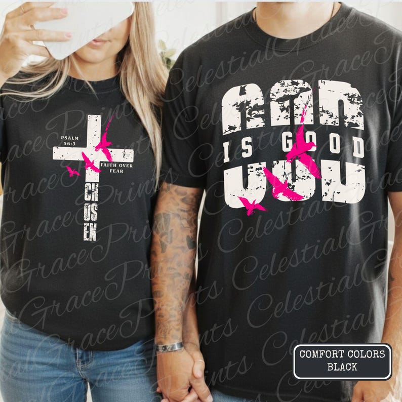 May include: Black t-shirts with white text and pink butterfly graphics. One shirt says "God is Good" and the other says "Chosen" with a cross design. The shirts are Comfort Colors.