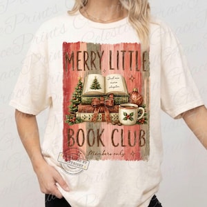 May include: A cream-colored short-sleeve t-shirt featuring a graphic print of stacked books, a Christmas tree, a mug, and the text MERRY LITTLE BOOK CLUB. The design includes a red and green color palette with a vintage-style striped background.