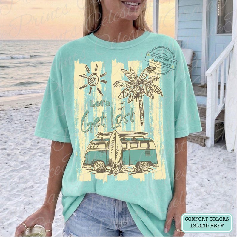 May include: A light teal t-shirt with a graphic design featuring a vintage teal and white van with a surfboard, a palm tree, and the text "Let's Get Lost". The design includes a sun and vertical yellow stripes.