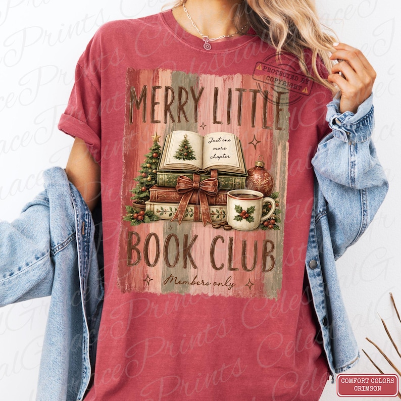 May include: A crimson short-sleeve t-shirt featuring a graphic of stacked books, a Christmas tree, a mug, and the text MERRY LITTLE BOOK CLUB, Just one more chapter, and Members only. The design includes holly berries and a decorative bow.