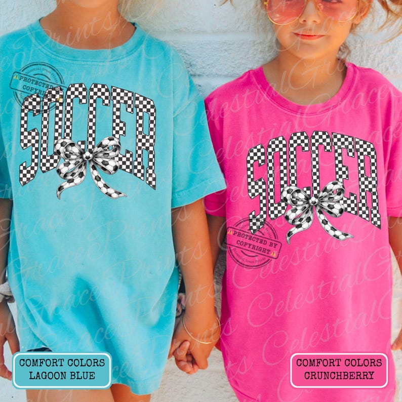 May include: Two short-sleeved t-shirts, one lagoon blue and one crunchberry pink, feature the word "SOCCER" in a checkered pattern with a soccer ball bow. The shirts have the text "COMFORT COLORS" and "PROTECTED BY COPYRIGHT" on them.