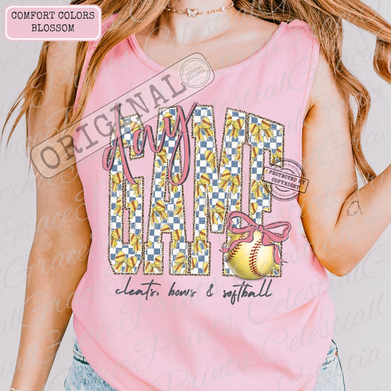 May include: Pink tank top with the words "Play Game" in a collegiate style font. The letters are decorated with a checkered pattern and bows. A softball with a pink bow is on the right. The text "cleats, bows & softball" is below.