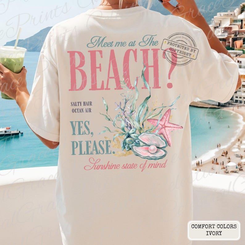 May include: Cream-coloured t-shirt with the text "Meet me at The BEACH?" in pink and teal. The shirt features a beach-themed graphic with a starfish, seashells, and the words "Salty Hair, Ocean Air, Yes, Please, Sunshine state of mind."