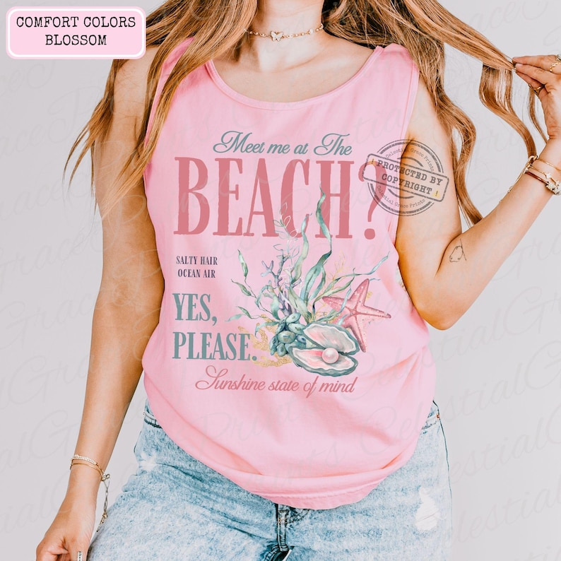 May include: A pale pink vest top featuring the words "Meet me at The BEACH?" in a vintage style. The design incorporates illustrations of seashells, starfish, and seaweed. The text "Salty Hair, Ocean Air, Yes, Please, Sunshine state of mind" is also included.