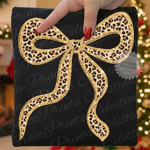 May include: Black square with a large bow design. The bow features a leopard print pattern with gold glitter accents. The words "Original Designer" and "Celestial Grace Prints" are visible.