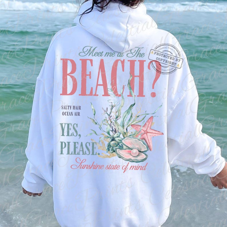 May include: White hoodie featuring a beach-themed design. The coral text reads "Meet me at The BEACH?" with illustrations of a starfish, seashells, and seaweed. The design also includes the phrases "Salty Hair, Ocean Air, Yes, Please, Sunshine state of mind".