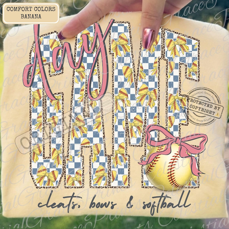 May include: A beige t-shirt with the words "My Game" in pink script and a blue and white checkered pattern. The letters are decorated with yellow bows and softballs. The phrase "cleats, bows & softball" is written below.