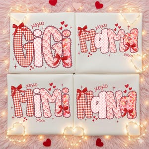May include: Four white square canvases with the words "GIGI", "Mama", "Mimi", and "Nana" in a bubble font. Each word is decorated with red bows, hearts, and a mix of heart and gingham patterns. The word "xoxo" is written above and below each word.