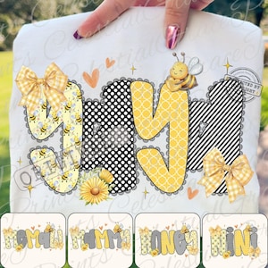 May include: White t-shirt with the word "YAY" in a playful design. The letters feature bee and floral patterns, polka dots, and stripes. A yellow bow and a smiling bee are also included in the design. The bottom of the shirt has the words "MOMMY HONEY MINI".