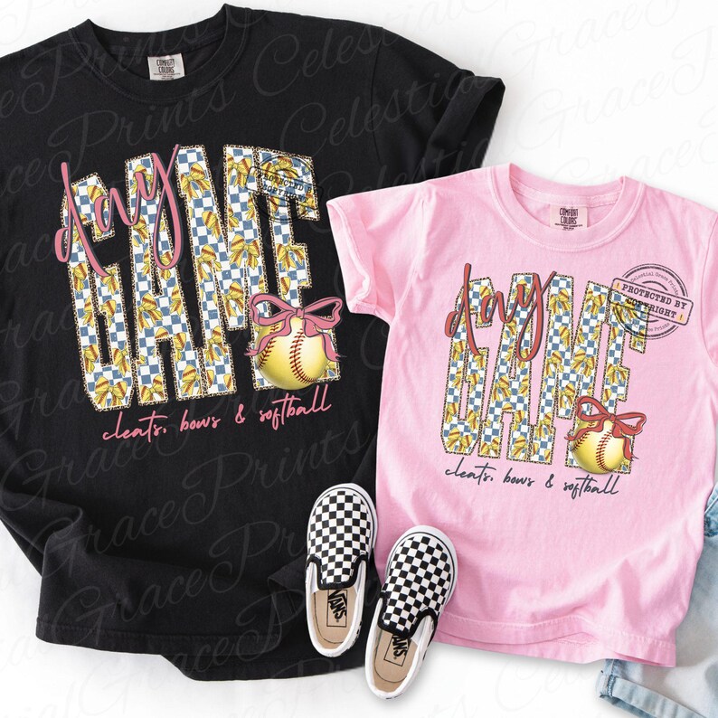 May include: Two t-shirts, one black and one pink, with a softball theme. The shirts feature the words "Game Day" in a checkered pattern, a softball with a pink bow, and the text "cleats, bows & softball". Checkerboard slip-on shoes are in front.