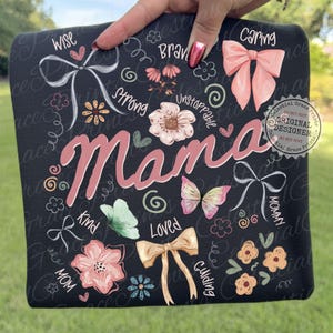 May include: Black square with the word "Mama" in pink script, surrounded by floral and bow illustrations. The design includes words like "Wise," "Caring," and "Loved." The words "Celestial Grace Prints" are also visible.