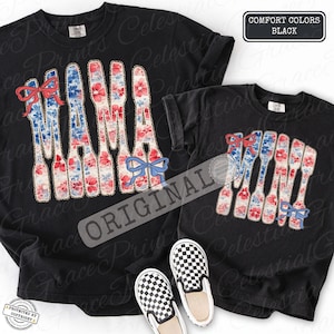 May include: Black Comfort Colors t-shirts with the word "MAMA" in a floral design with red, white, and blue accents. The shirts have red and blue bows. A pair of black and white checkered slip-on shoes are at the bottom.