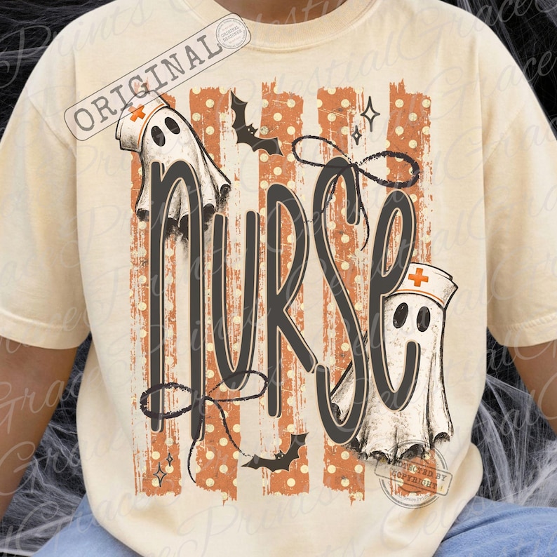 May include: A cream-colored t-shirt featuring a graphic print with the word NURSE in large black letters. The design includes two white ghosts wearing nurse caps with orange crosses, orange vertical stripes with white polka dots, and black bats.