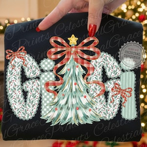 May include: Black t-shirt with a Christmas-themed design. The word "GIFT" is spelled out with decorative letters. A Christmas tree with a red plaid bow and star is in the center. The letters are decorated with holly and plaid patterns.