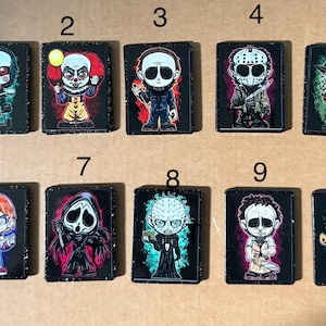 May include: A set of ten rectangular patches featuring cartoon-style horror characters. Each patch has a black border and a unique character illustration, including figures like a clown, a masked slasher, and a doll, numbered one through ten.
