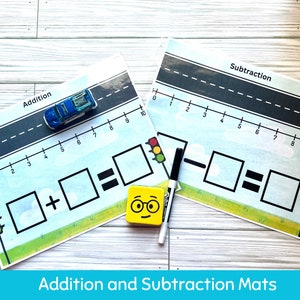 May include: Two colorful educational mats for kids to learn addition and subtraction. Each mat features a number line, a toy car, and traffic lights. The mats are designed to help children visualize math concepts.
