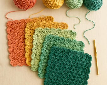 May include: A collection of colorful crochet squares in shades of orange, yellow, green, and teal, with matching yarn balls. A gold crochet hook is also present, suggesting a crafting theme. The squares have a scalloped edge.