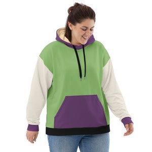 Puede incluir: Una sudadera con capucha de gran tama&ntilde;o en verde, morado y blanco con un cord&oacute;n de ajuste negro y un bolsillo canguro. La sudadera tiene un corte holgado y es perfecta para superponer.