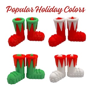 May include: Four pairs of decorative boot-shaped bottle stoppers in red, green, and white. The stoppers have a festive design with red and green or white and red accents, perfect for holiday celebrations. The text "Popular Holiday Colors" is at the top.