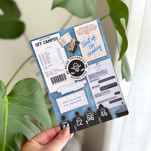 May include: A collage-style print featuring text and graphics. The print includes a hockey club logo, text that reads "Shut up, I'm reading," and a list of items. The bottom of the print shows hockey player silhouettes with jersey numbers.