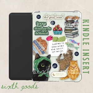 May include: A black Kindle device with a clear insert featuring cat illustrations and text. The insert has a green and white striped background with phrases like "hot girls read" and "Sorry my standards are fictional."