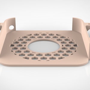 May include: A light peach-colored, geometric-patterned bracket with a circular opening and hexagonal cutouts. The bracket has a rectangular base with curved edges and raised side supports, each with mounting holes.