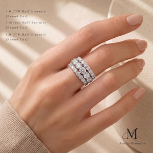 May include: A silver-toned ring featuring seven round-cut stones in a half-eternity setting. The text on the image reads 1.0 CTW Half Eternity [Round Cut], 7 Stones Half Eternity [Round Cut], and 1.0 CTW Half Eternity [Round Cut].