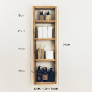 May include: A wooden shelf unit with four shelves, measuring 100cm tall, 30cm wide, and 40cm deep. The shelves are filled with various items, including towels, toiletries, and plants. The shelf unit is a great way to organize and display items in a bathroom or other room.