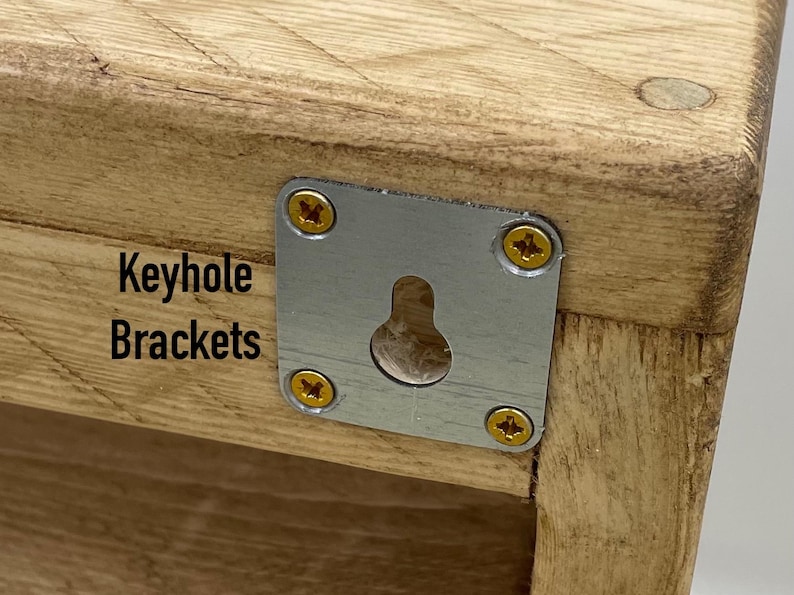 May include: Close-up of a wooden shelf with a metal keyhole bracket attached. The bracket has four screws and a keyhole opening. The text "Keyhole Brackets" is printed on the wood.