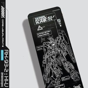 May include: Black bookmark with a white line drawing of a robot and the text "SERIAL: RX932-EX// ALPHA-VX" and "SYSTEM UPLINK: [NEON FRAME]" printed on it. The bookmark also has the text "RX-93-2: HI-U" and "BOOKMARK" on the side.