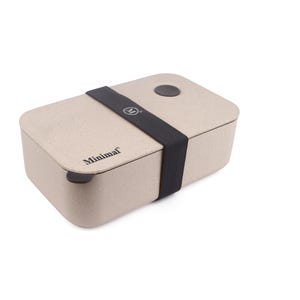 May include: A rectangular beige bento box with a speckled texture, featuring a black elastic band wrapped around the center. The word Minimal is printed in black on the lid, along with a small circular black logo on the band and a circular vent.