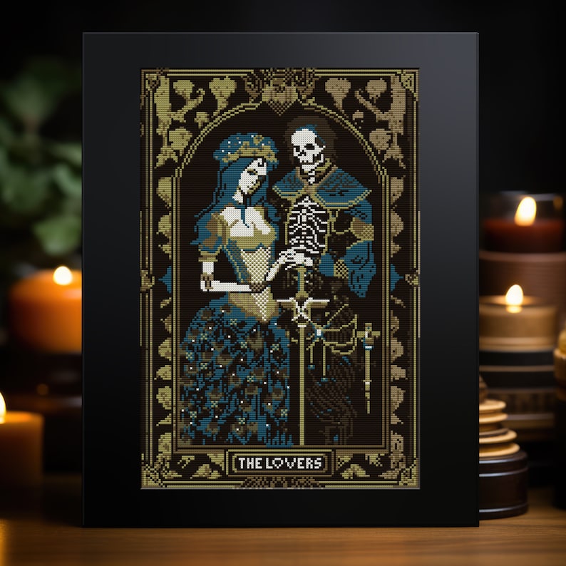 A digital render of 'The Lovers' (Love Never Dies) Tarot cross stitch design. Presented in the format of a greetings card with candles in the background. Strong black, white, gold and blue DMC thread colours.
