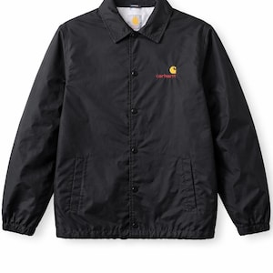 May include: Black coach jacket with a button-up front, collar, and two front pockets. The jacket features the Carhartt logo in yellow and orange on the chest. The jacket is made of a lightweight material.