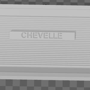 May include: A white plastic panel with a horizontal ribbed texture and the word "CHEVELLE" embossed in the center.