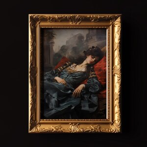 May include: A framed painting of a woman in a blue dress sleeping on a red pillow. The woman has long dark hair and is wearing a gold necklace. The background is a blurry image of a garden.