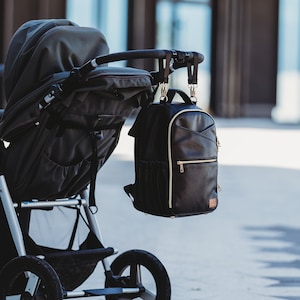 Stylish vegan leather premium diaper bag backpack, changing nappy bag, travel diaper bag. Free shipping.