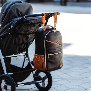 Stylish vegan leather premium diaper bag backpack, changing nappy bag, travel diaper bag. Free shipping.