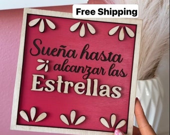 May include: A wooden sign with a red background and white lettering. The sign says "Sueña hasta alcanzar las Estrellas" which translates to "Dream until you reach the stars".